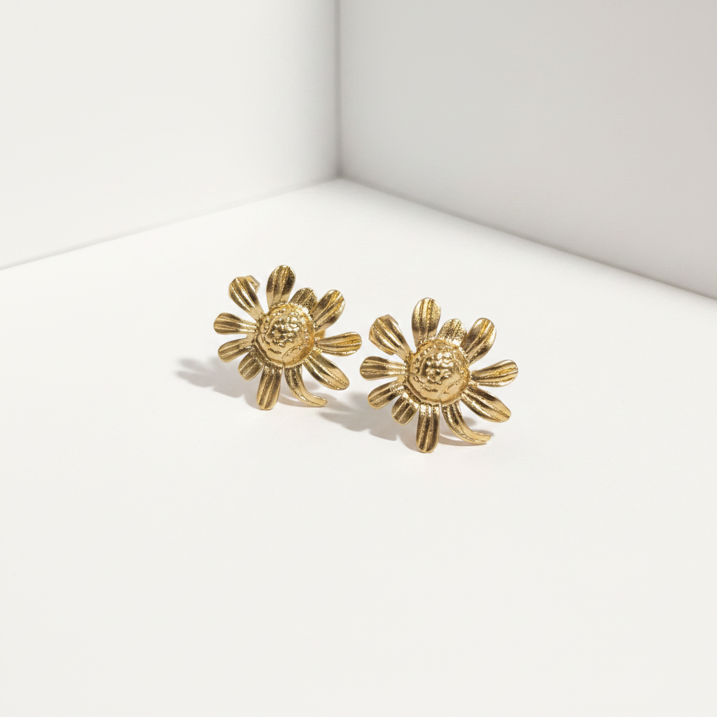 Gold daisy flower stud earrings with ribbed petals and textured dome center